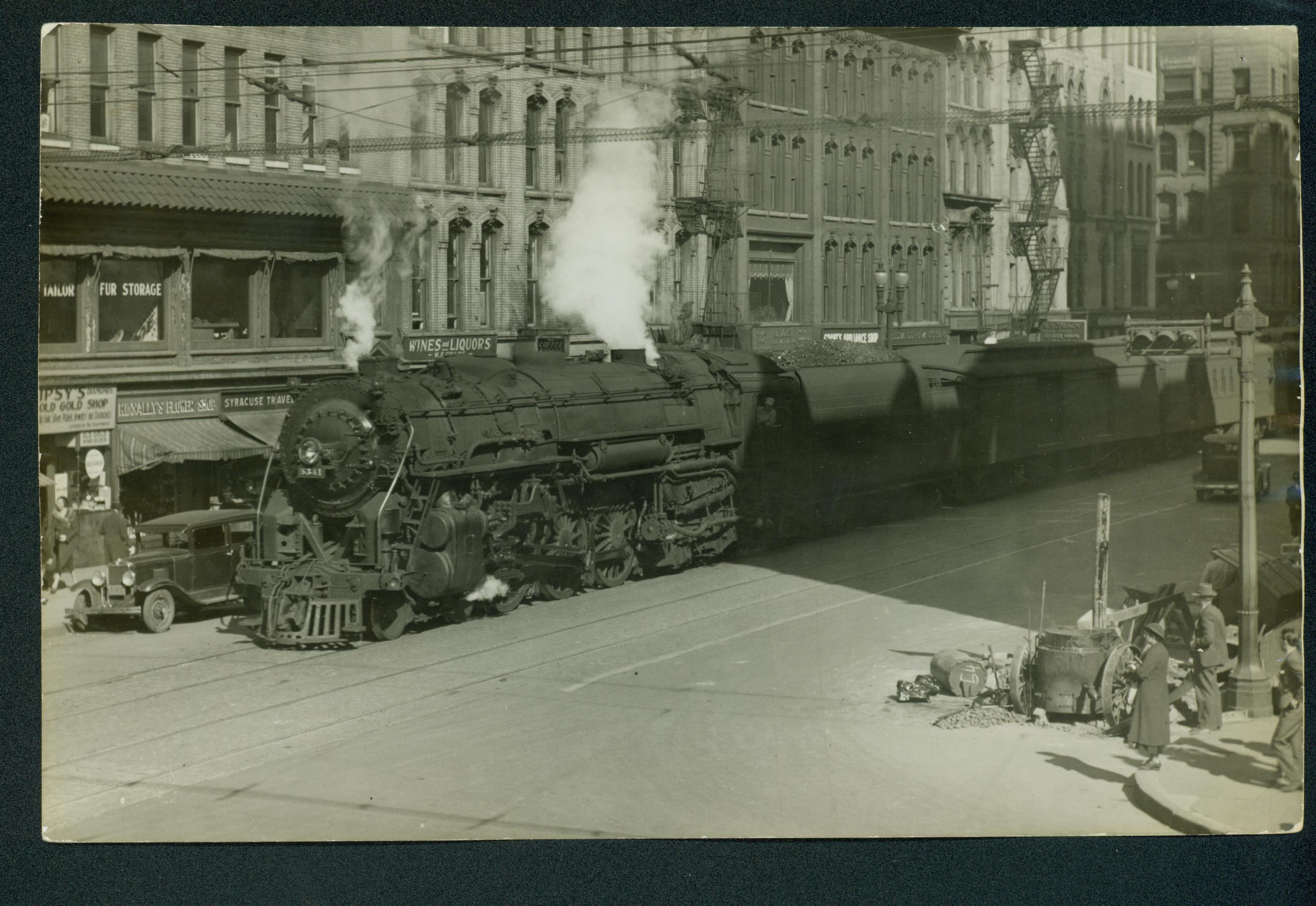 A westbound NY Central passenger train circa 1920's about to cross South Salina Street.  Photo courtesy Onondaga Historical Association.